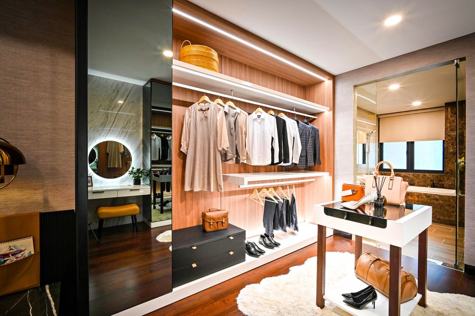 Luxury walk in closet with custom shelving and lighting
